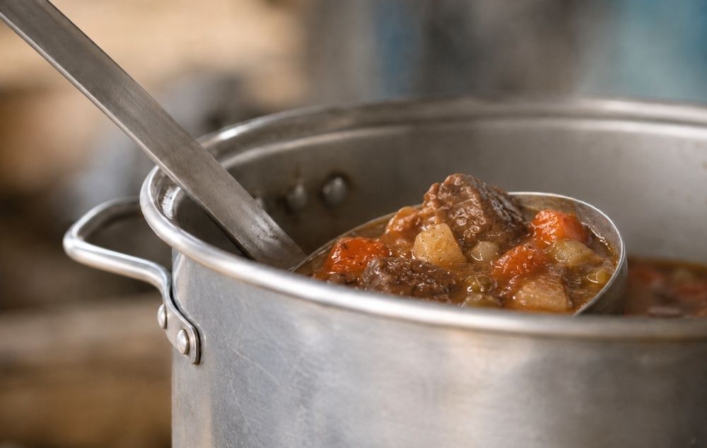 People sharing food representing meals provided through Rooted